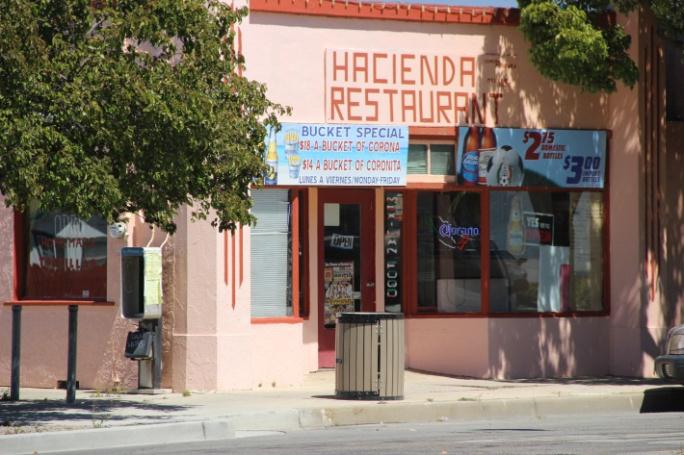 A pink restaurant building on a downtown corner.
