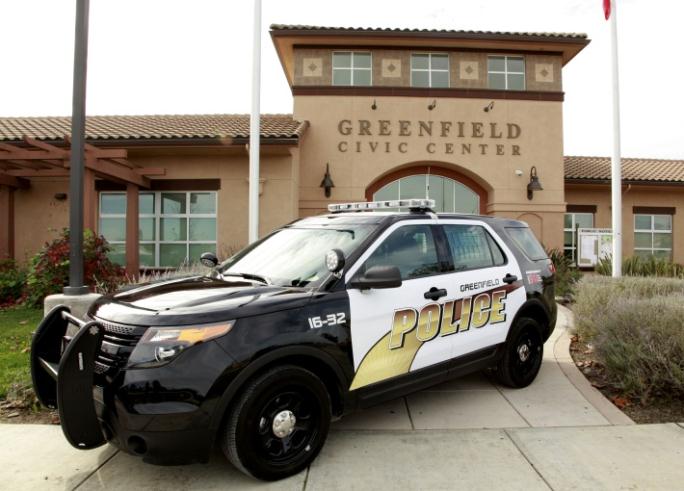 A police cruiser in front of the Greenfield Civic Center.
