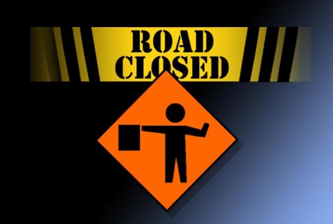 An orange road closed sign.