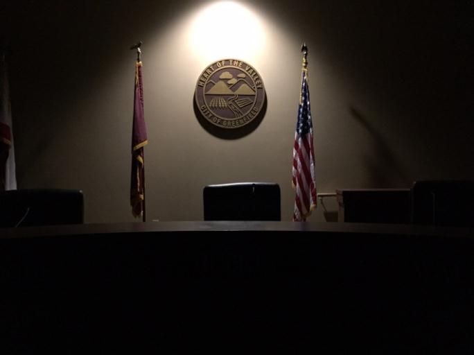 A large desk with an American flag behind it.
