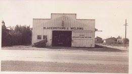 A black and white photo of a stand alone building.