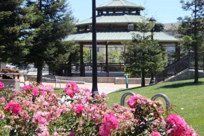 A large gazebo in the middle of a park.